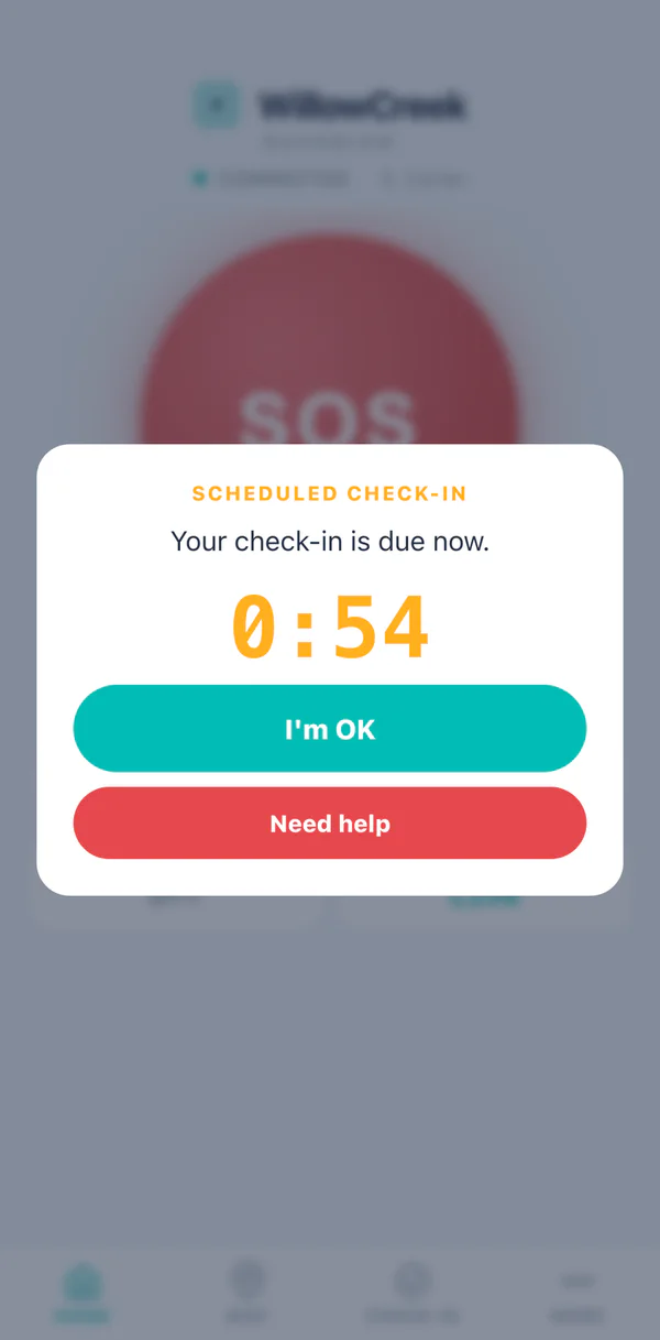 A scheduled check-in prompt on the handset, over the home screen, with its own grace countdown and two buttons: I am OK, and Need help.